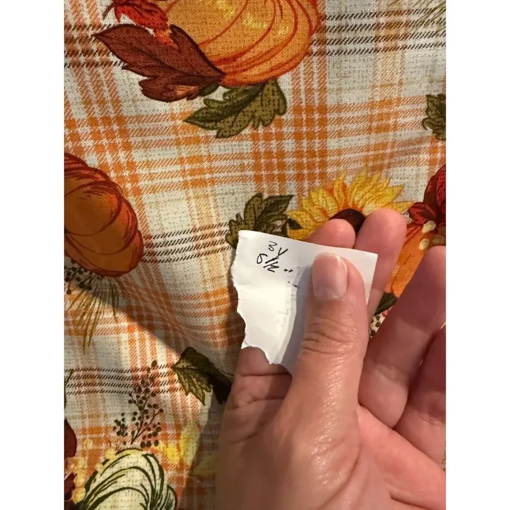 Joanne Fabrics harvest-themed pumpkins and sunflowers on a plaid background